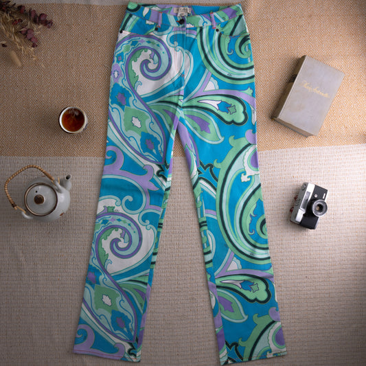 Vintage Etro Milano Deadstock Y2K Paisley Print Jeans – bold psychedelic large-scale paisley swirl print in turquoise blue, mint green, lavender and white stretch denim, mid rise, five-pocket straight leg cut, single button closure, Etro label at waistband, boho Italian luxury, flat lay editorial shot