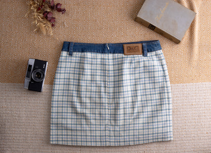 back view Vintage D&G Dolce Gabbana Y2K Mixed Media Mini Skirt – pale blue and white houndstooth tweed body with contrasting indigo denim waistband, two denim patch pockets with gold D&G logo patch, back zip closure, straight mini silhouette, flat lay editorial shot