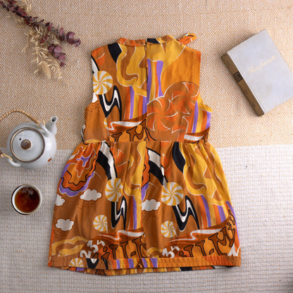 back view Vintage Miu Miu Silk Tunic Top – vibrant orange silk with psychedelic mod print featuring swirling clouds, stars, eyes, mushrooms and abstract shapes in purple, black and white, jewel neckline with ruffle trim, sleeveless, back zip, baby doll silhouette, Miu Miu label, flat lay editorial shot