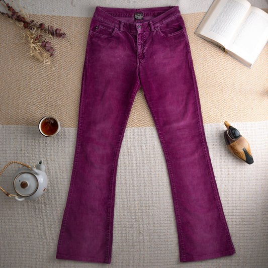 Vintage Miss Sixty Y2K Purple Corduroy Flare Bootcut Trousers – rich magenta purple fine-wale corduroy with subtle acid wash patina, mid rise, five-pocket construction, Miss Sixty logo label at waistband, flared bootcut leg, 90s grunge aesthetic, flat lay editorial shot