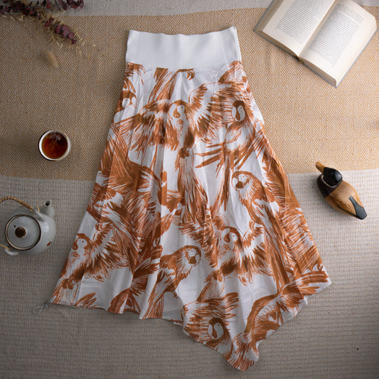 Vintage Sportmax Code Tropical Parrot Print Asymmetric Midi Skirt – white cotton with all-over rust orange sketched parrot and tropical bird print, wide structured white waistband, flowing asymmetric handkerchief hem, resort wear summer aesthetic, flat lay editorial shot