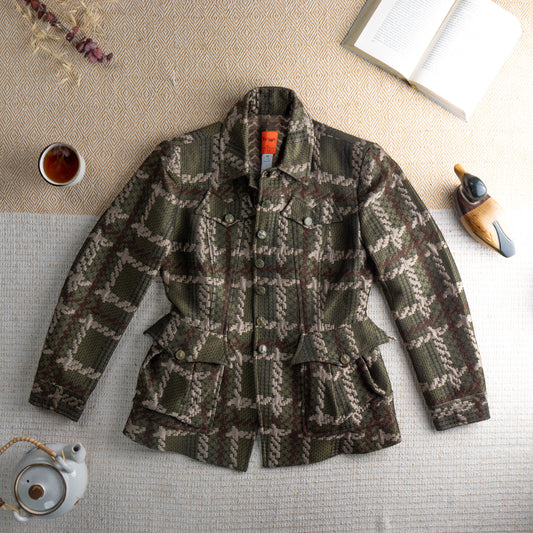 Deadstock Christian Lacroix Bazar 90s Safari Blazer – olive green and sand earth tone geometric jacquard, point collar, single-breasted with pearl-effect buttons, dual chest flap pockets, dual hip bellows pockets, fitted waist, long sleeves with button cuffs, Made in France, unworn with original orange label, flat lay editorial shot