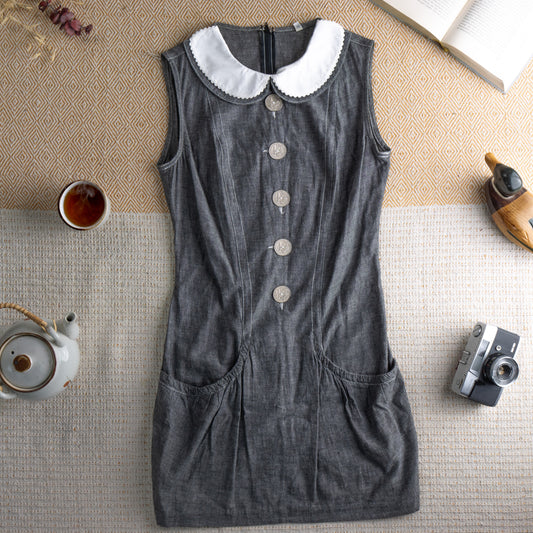 Archival Fendissime by Fendi 1987 Mod Mini Dress – dark grey chambray denim, white scalloped Peter Pan collar, sleeveless, four large silver Fendi logo coin buttons at centre front, vertical seam panelling, two hip patch pockets, body-con silhouette, Karl Lagerfeld era, flat lay editorial shot