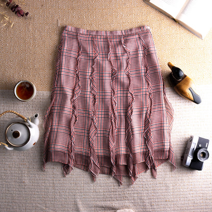 Vintage Cacharel Y2K Silk Ruffled Houndstooth Plaid Midi Skirt – blush pink, green and white houndstooth check silk, high waist, five vertical ruffle seam panels creating deconstructed avant-garde silhouette, raw fringe hem, A-line midi length, flat lay editorial shot