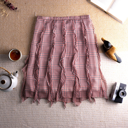 view back Vintage Cacharel Y2K Silk Ruffled Houndstooth Plaid Midi Skirt – blush pink, green and white houndstooth check silk, high waist, five vertical ruffle seam panels creating deconstructed avant-garde silhouette, raw fringe hem, A-line midi length, flat lay editorial shot