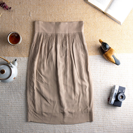 Vintage Fendi 100% Silk Pencil Skirt – champagne beige silk, wide structured high waistband with fine pleated yoke gathering, draped pencil midi silhouette with banded hem, 90s minimalist Italian luxury, flat lay editorial shot