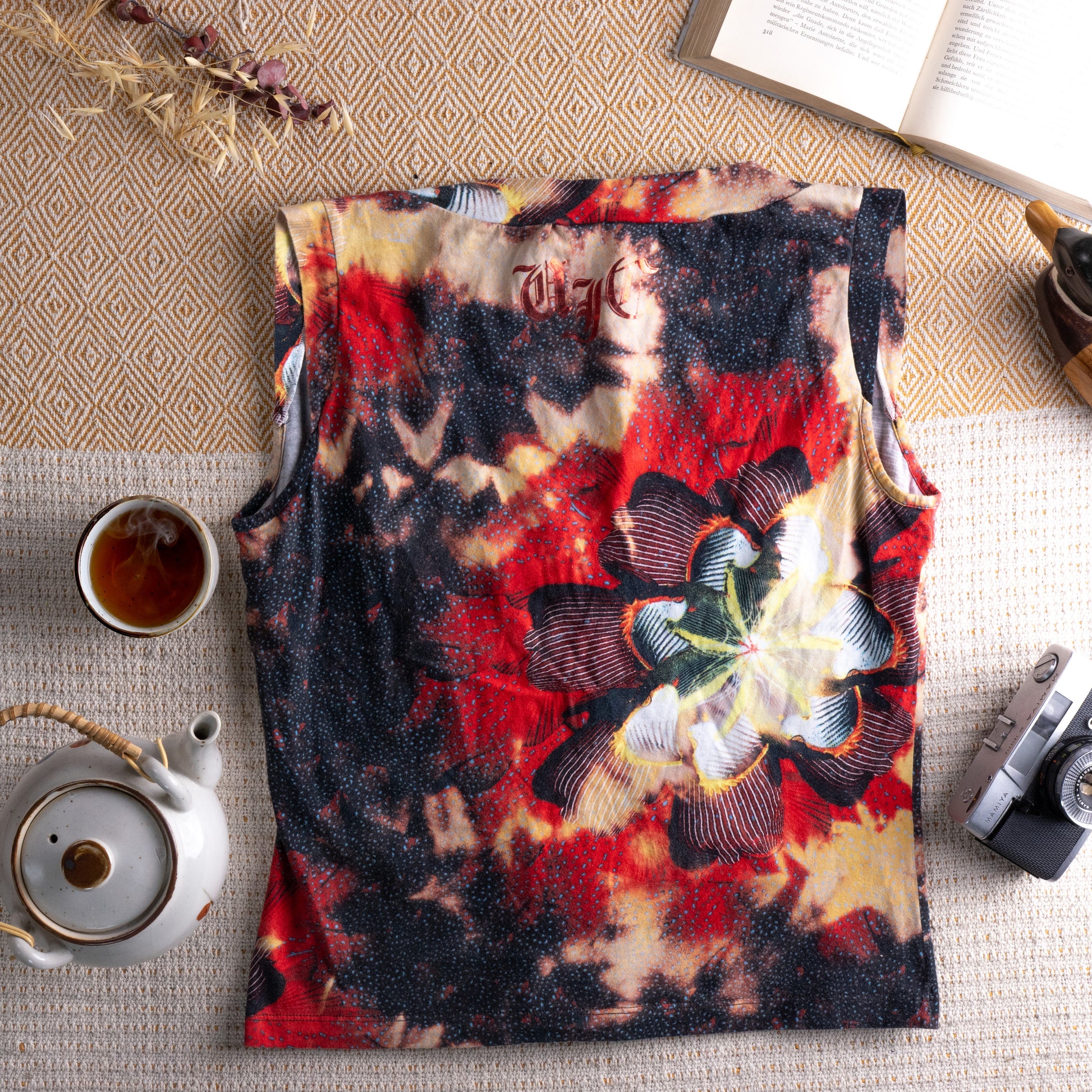 back view Vintage Versace Jeans Couture 90s Y2K Floral Gothic Print Tank Top – dark abstract floral print in crimson red, black, sand and yellow on cotton, deep V-neckline, sleeveless, relaxed boxy fit, Versace Jeans Couture label, ITTIERRE Made in Italy archival designer, flat lay editorial shot