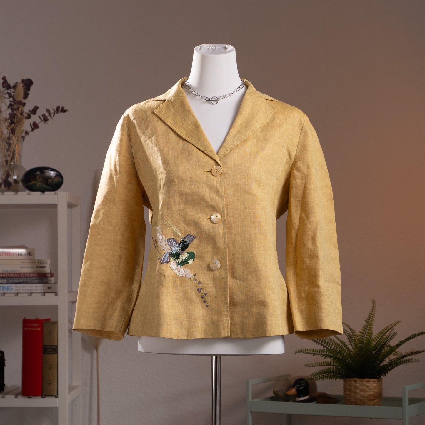 NOS Archival Kenzo Jungle Paris Deadstock 90s Yellow Linen Blazer – warm golden yellow linen, notch lapel, single-breasted with three mother-of-pearl buttons, 3D hummingbird and floral appliqué at lower front, long sleeves, fitted silhouette, product shot on dress form