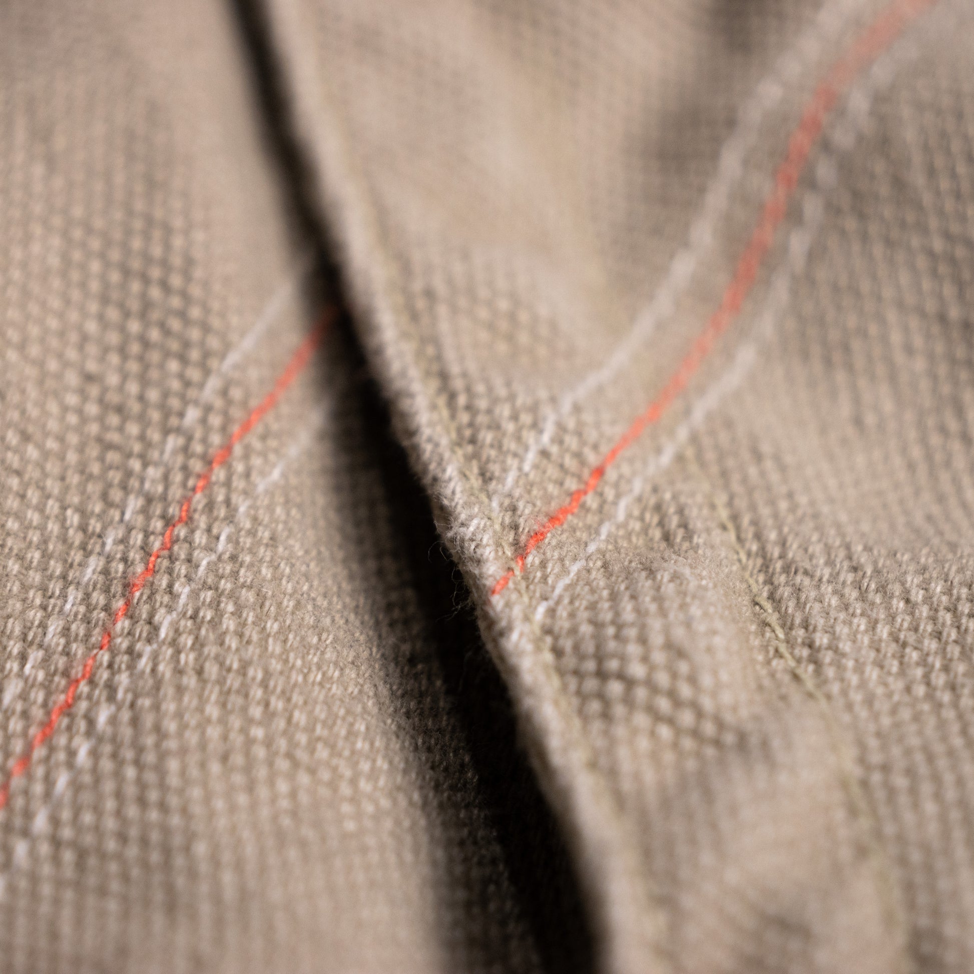 Detailed macro shot of the archival Diesel mini skirt's side twill tape, showcasing intricate contrasting off-white soutache chain-stitch embroidery in organic botanical vine motifs.
