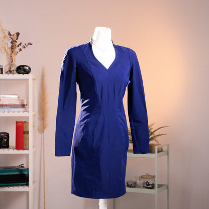 Archival Thierry Mugler Activ royal blue hourglass dress from the 1990s, showcasing structural panels, a deep V-neckline with a standing mandarin collar, and sharp padded shoulders. Front view on mannequin, pristine New Old Stock condition.
