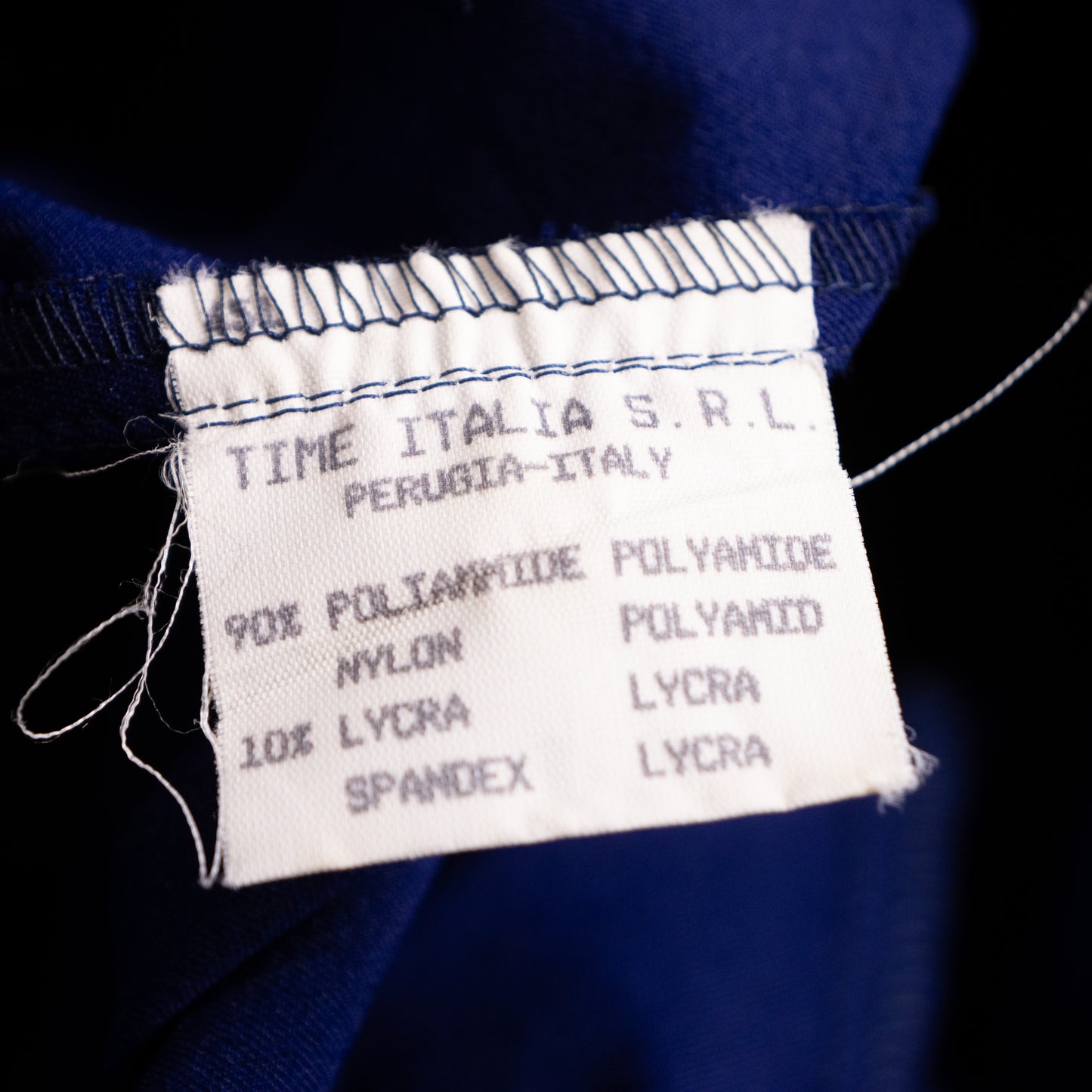 Vintage interior care label from Time Italia S.r.l. Perugia-Italy, displaying the fabric composition of 90% Poliammide Polyamide Nylon and 10% Lycra Spandex Lycra. Ultimate provenance proof for high-end fashion archivists.
