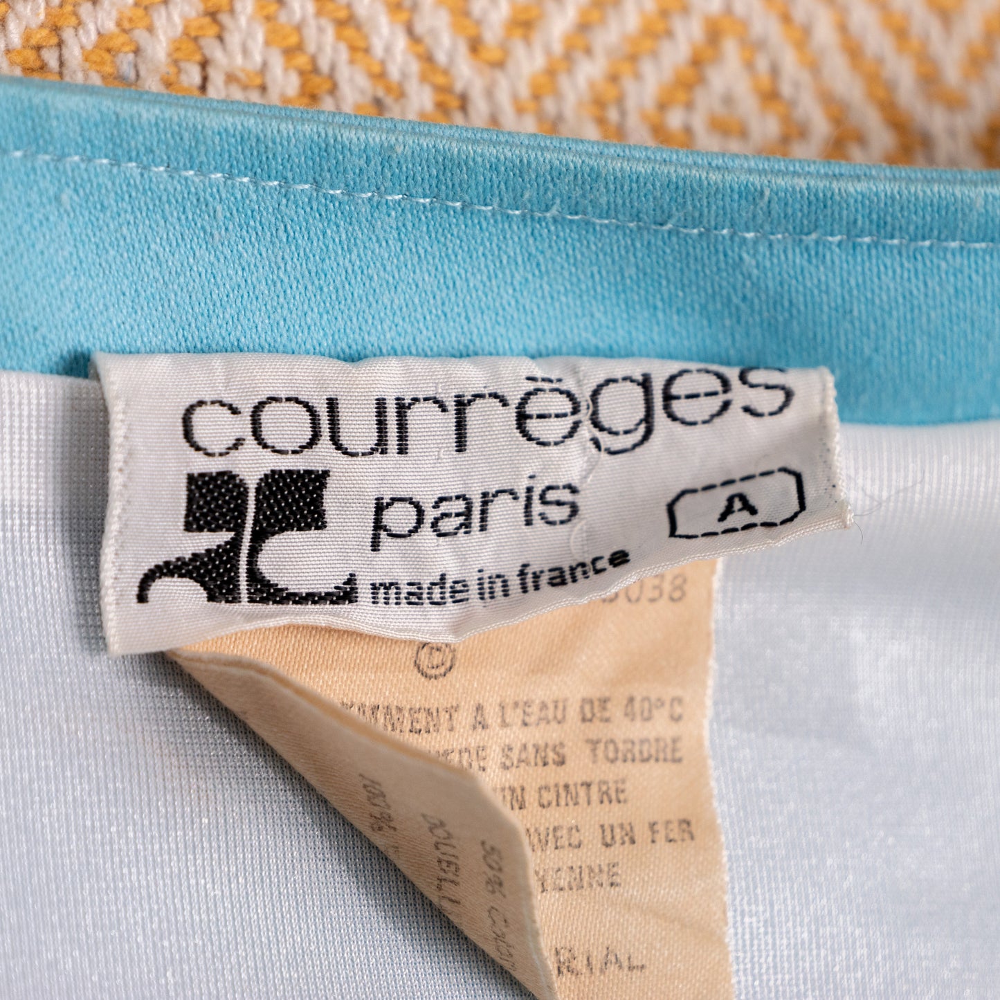 Historical vintage Courrèges Paris interior care label, displaying "FABRIQUE EN FRANCE" and official register code "MODELE/STYLE: 13038" with crisp textile print, proving near-deadstock archive state.
