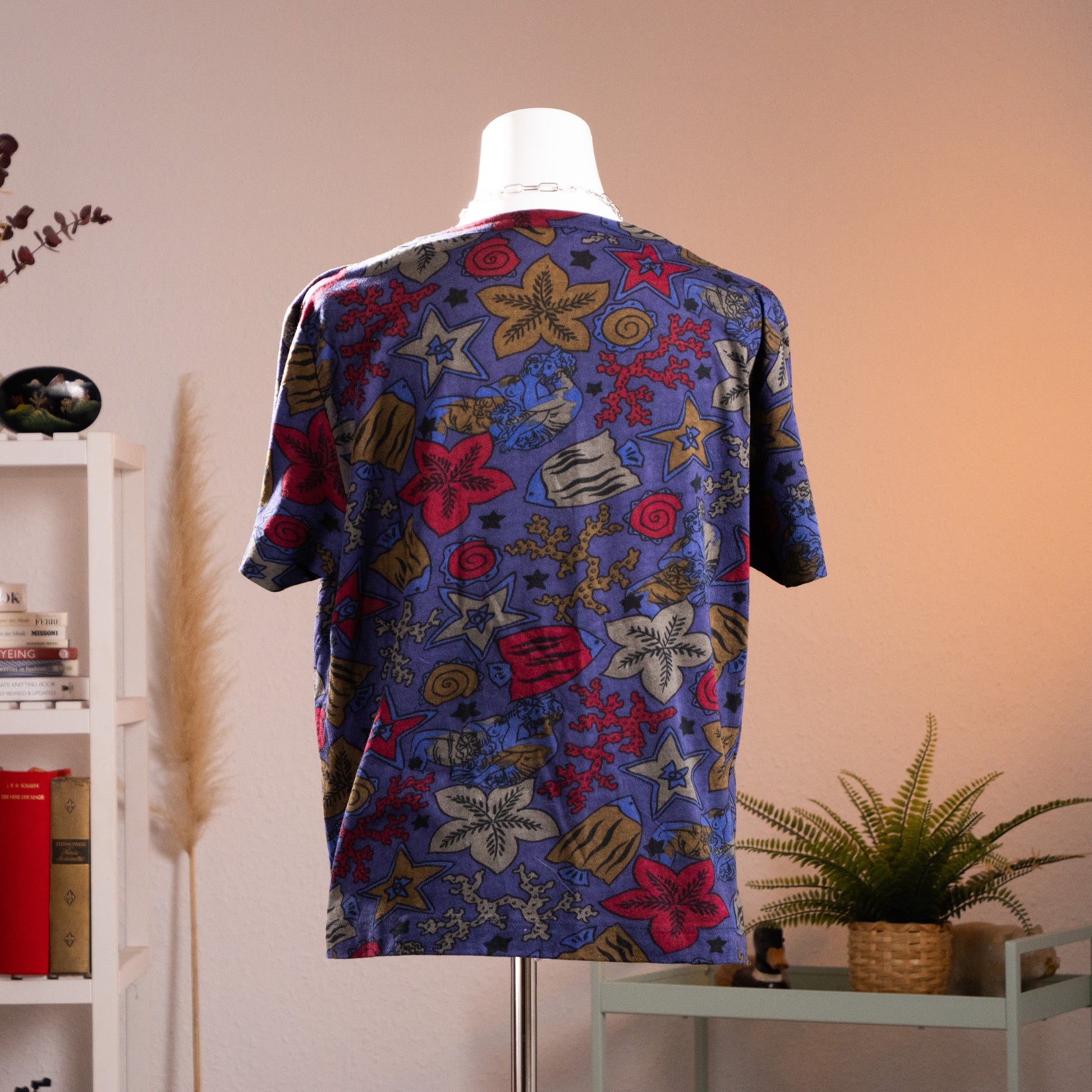 Back view of authentic 1980s Gucci marine life all-over print unisex t-shirt showcasing the continuous fish and coral pattern across the shoulders and back.

