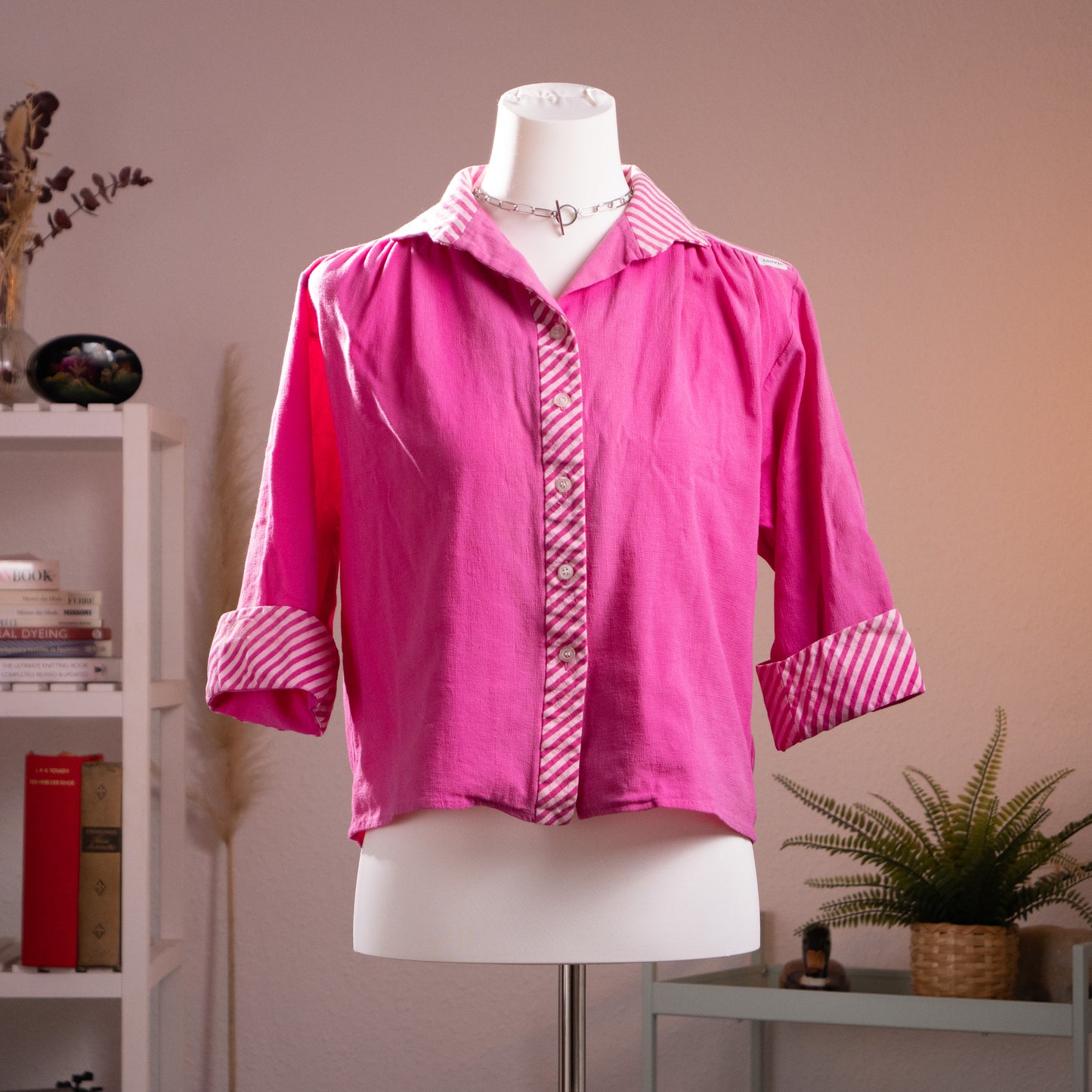 Front view of authentic vintage 1980s Lanvin fuchsia cropped blouse with candy-stripe cuffs and placket on a mannequin