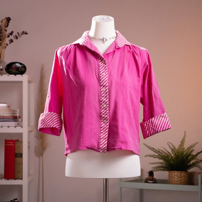 Front view of authentic vintage 1980s Lanvin fuchsia cropped blouse with candy-stripe cuffs and placket on a mannequin