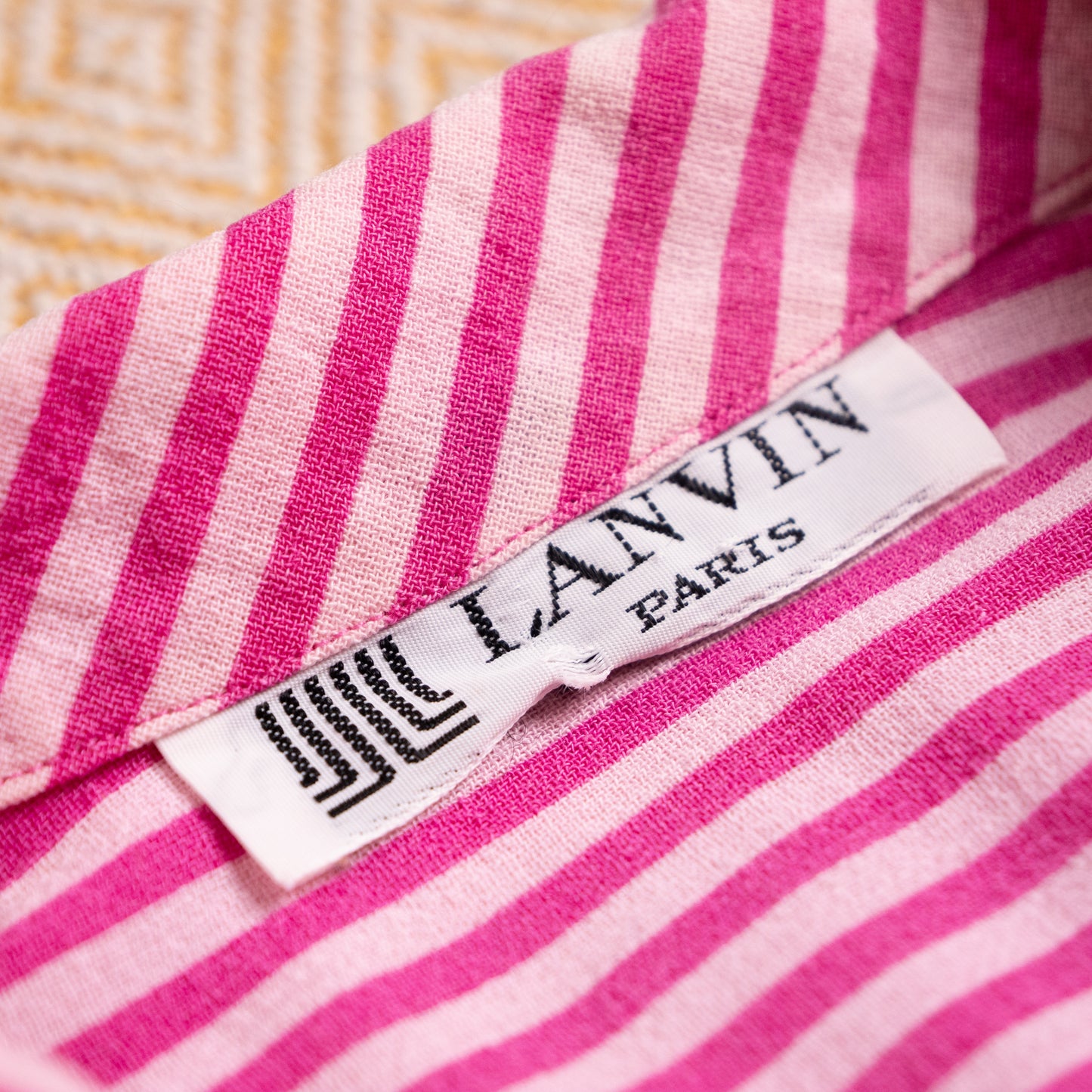 Close-up of authentic vintage mid-to-late 1980s Lanvin Paris woven neck label with geometric JL monogram on candy-stripe backing.