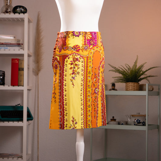 Front view of authentic vintage Anna Molinari Blumarine yellow and orange paisley silk midi skirt on a white mannequin.