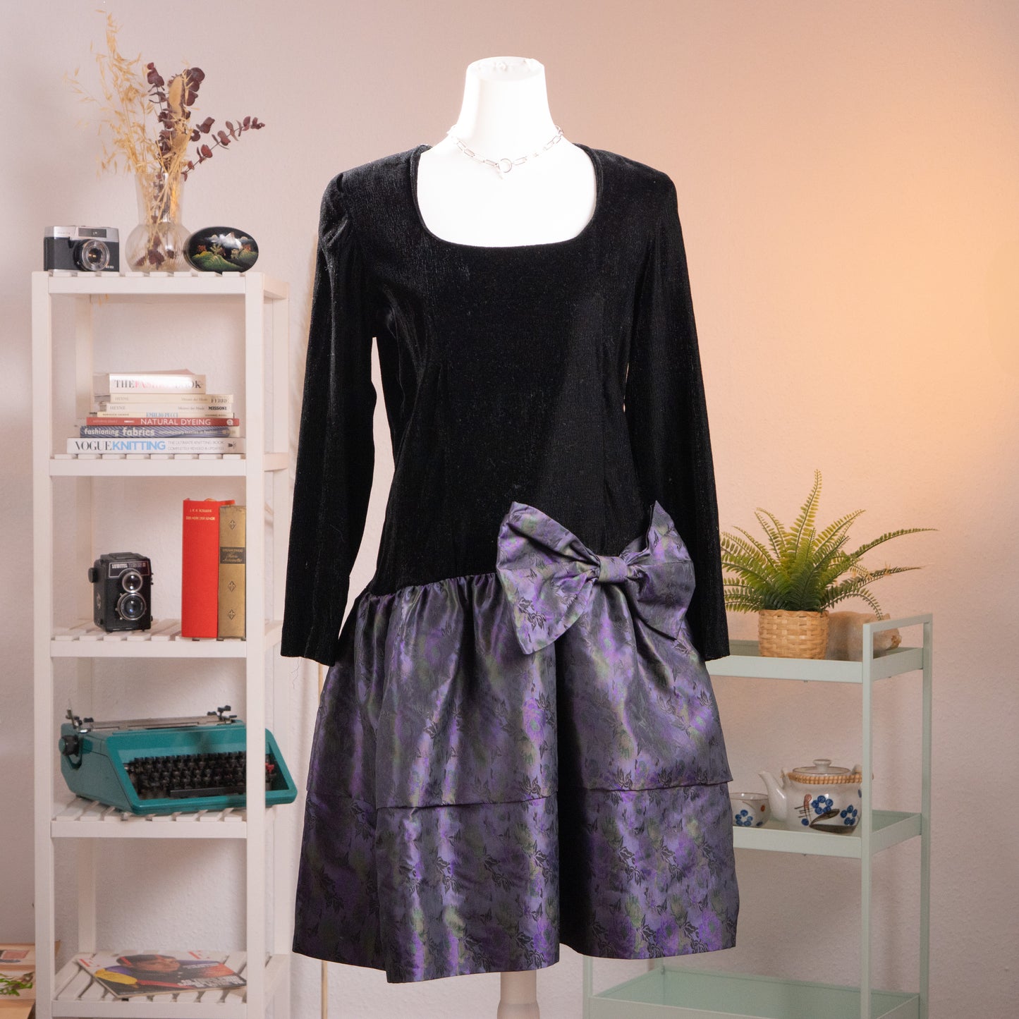 Front view of an archival KL by Karl Lagerfeld black crêpe and iridescent purple silk jacquard balloon dress from the late 1980s on a mannequin.