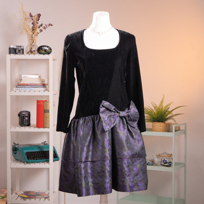 Front view of an archival KL by Karl Lagerfeld black crêpe and iridescent purple silk jacquard balloon dress from the late 1980s on a mannequin.