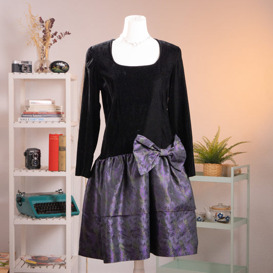 Front view of an archival KL by Karl Lagerfeld black crêpe and iridescent purple silk jacquard balloon dress from the late 1980s on a mannequin.