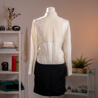 Back view of the archival Alexander McQueen dress showing the seamless geometric alignment of the black and ivory panels.