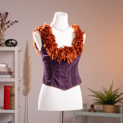 Front view of the archival mid-90s Lolita Lempicka paneled corset top on a museum mannequin, highlighting the sweetheart neckline with tinsel shag fringe.