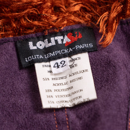 Close-up interior shot of the woven black Lolita Lempicka Paris label with red leaf motif and care instructions inside the archival fringe corset.
